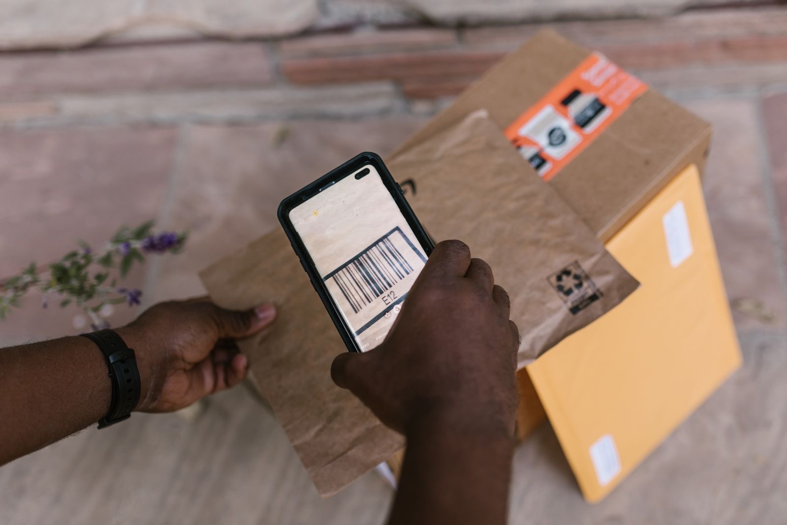 A phone scanning a barcode beside an envelope