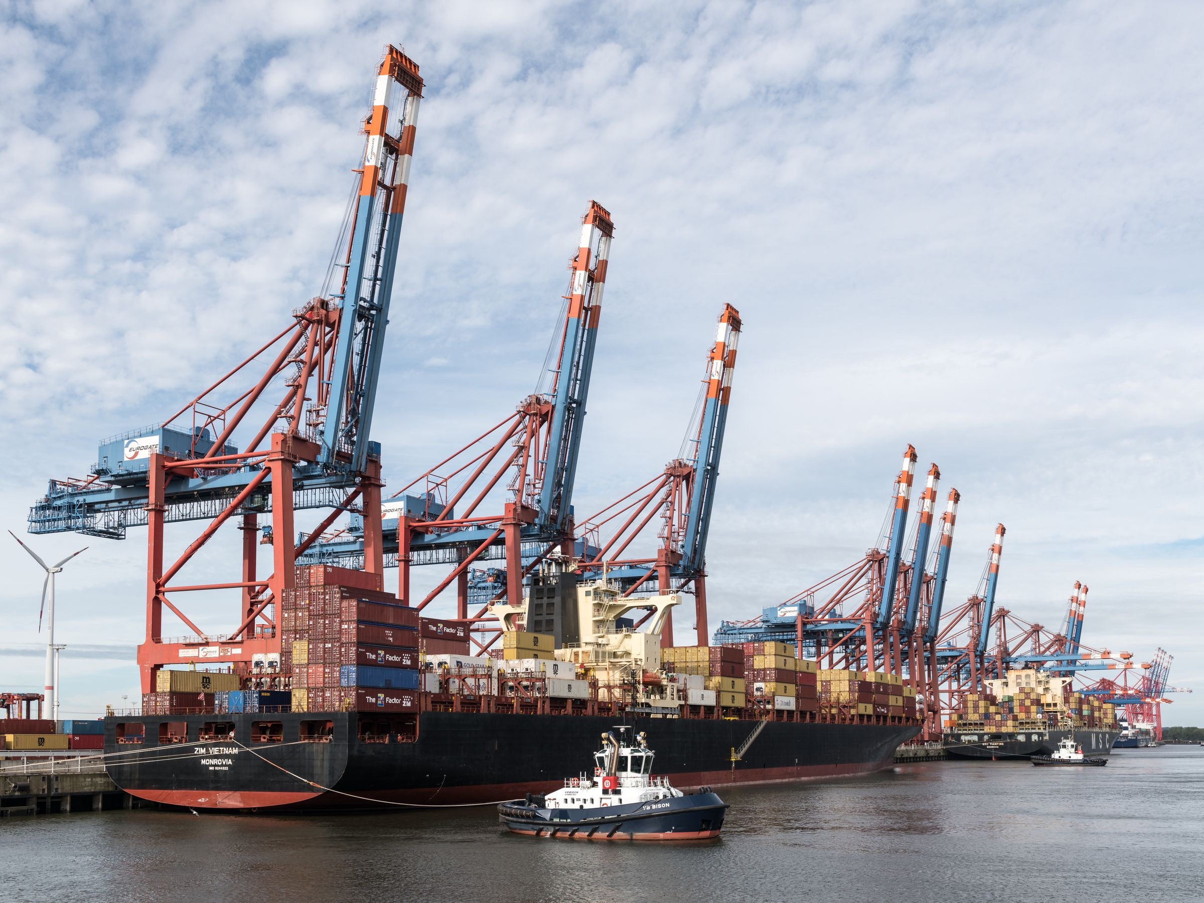 Stacked shipping containers at a quay waiting to be unloaded