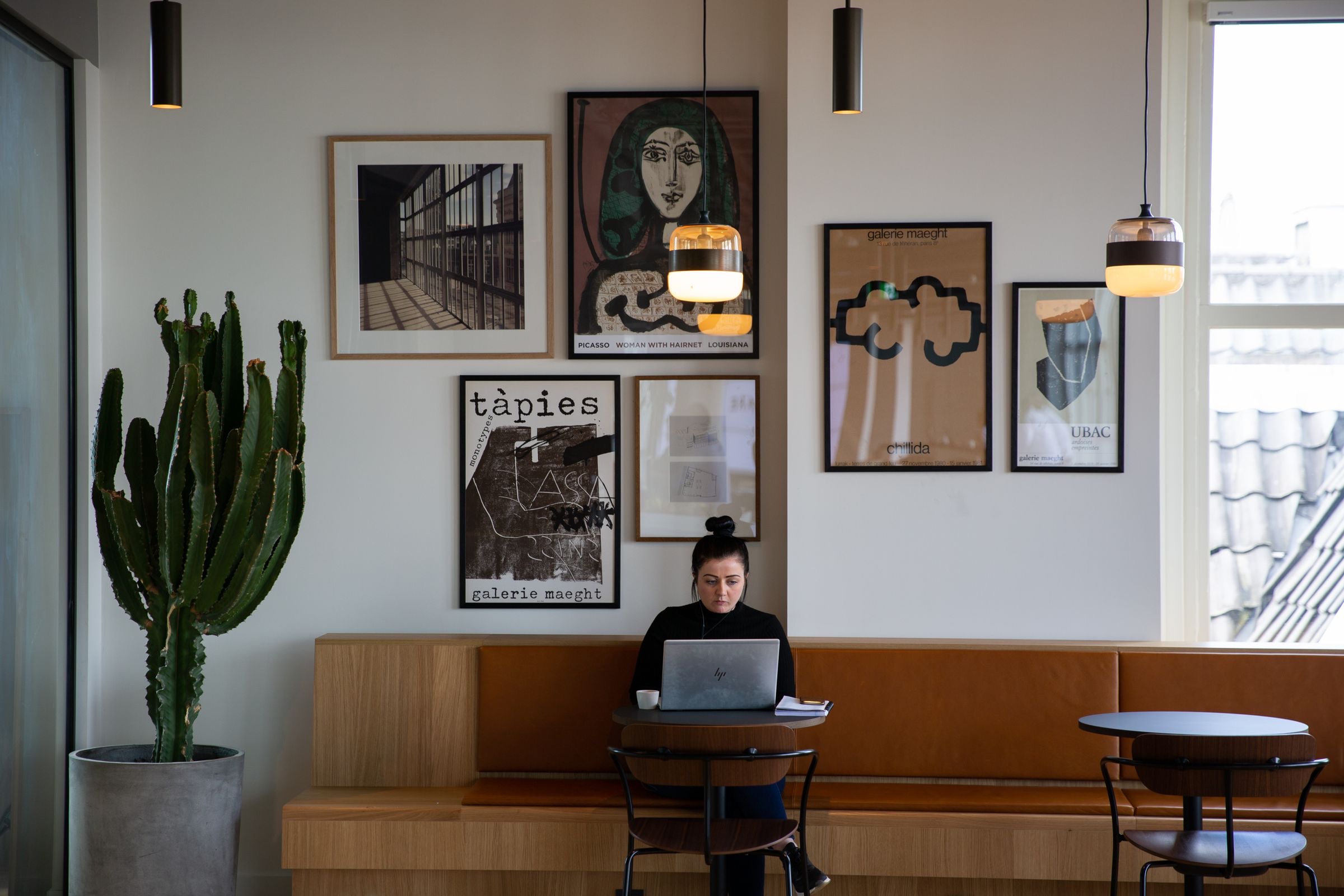 A freelancer working on a laptop at a cafe table